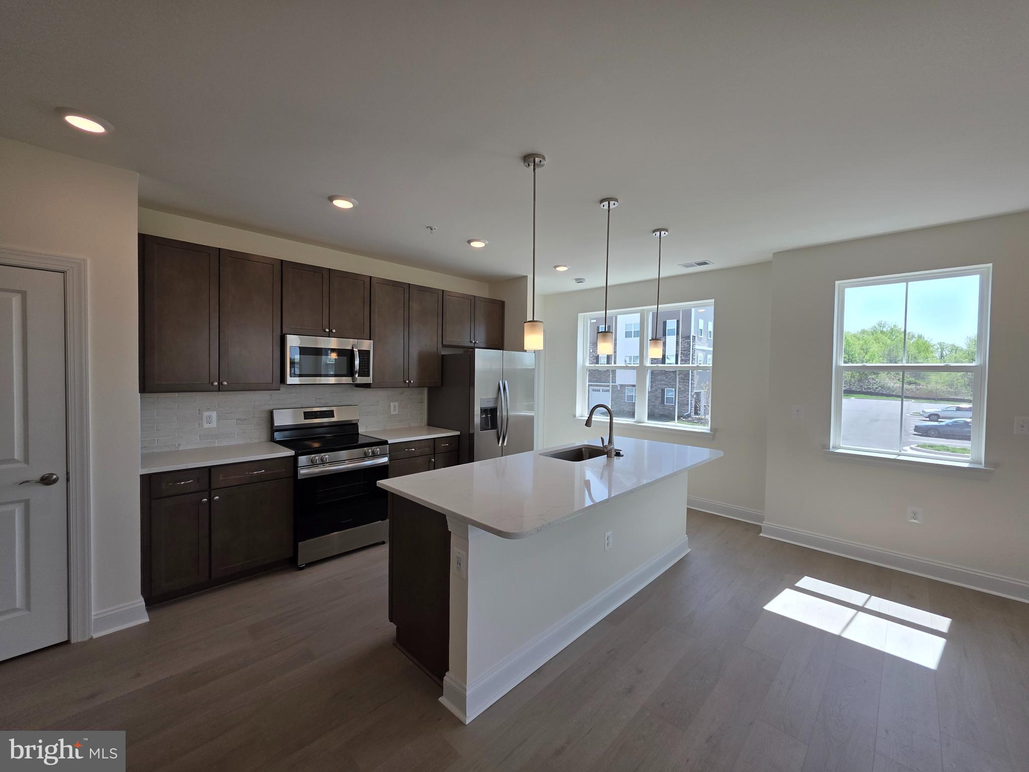 404 Bold Ruler Court, Unit 201 Havre de Grace, MD 21078 - Photo 29 of 43 a large kitchen with stainless steel appliances granite countertop a sink a stove a refrigerator a center island and a window