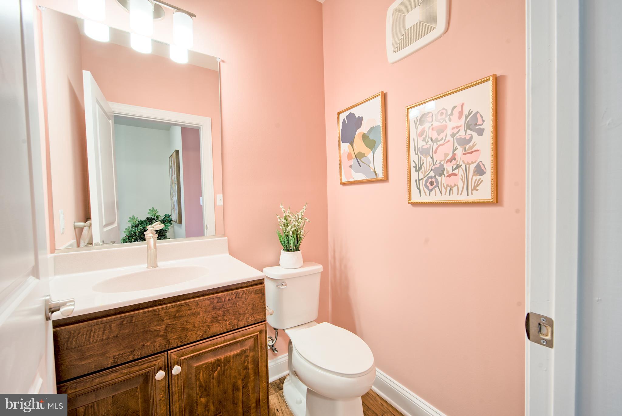 404 Bold Ruler Court, Unit 201 Havre de Grace, MD 21078 - Photo 5 of 43 a bathroom with a toilet a sink and a mirror