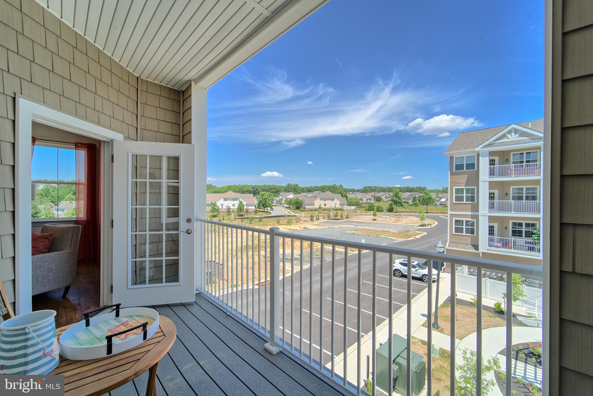 404 Bold Ruler Court, Unit 201 Havre de Grace, MD 21078 - Photo 8 of 43 a view of a balcony with chair and wooden floor