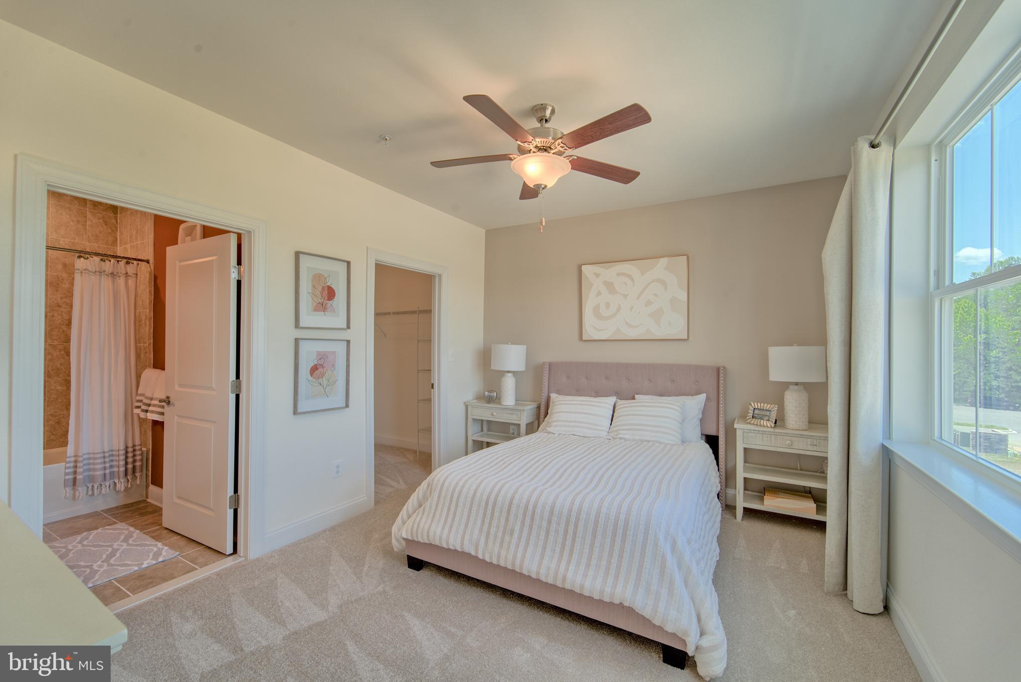 404 Bold Ruler Court, Unit 201 Havre de Grace, MD 21078 - Photo 9 of 43 a bedroom with a large bed and a chandelier