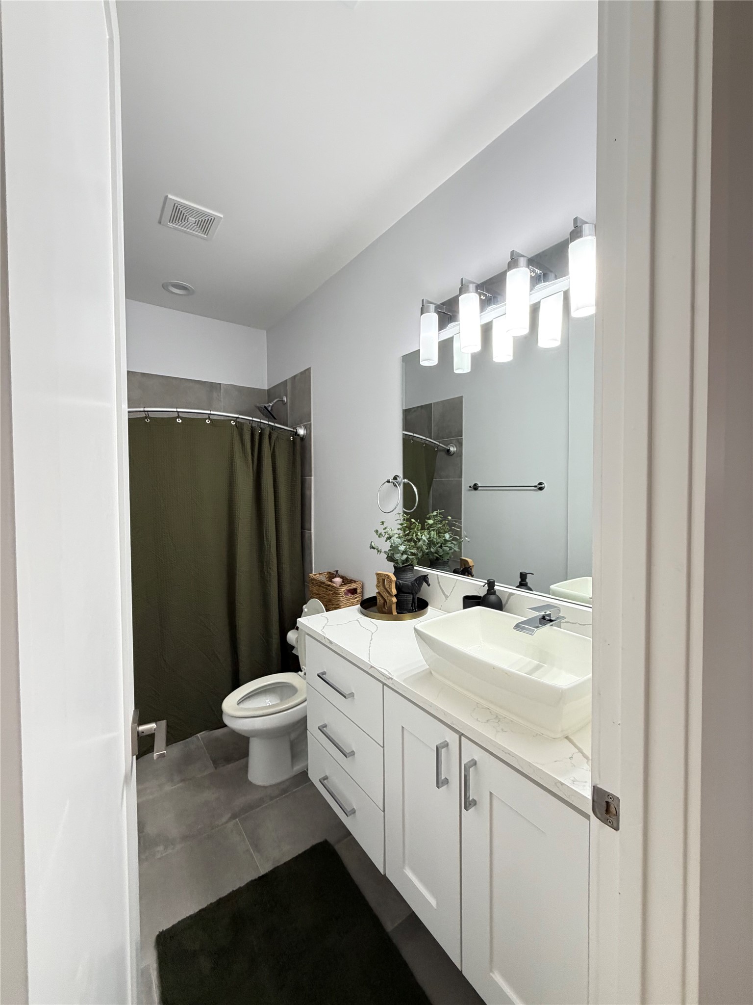 17216 Lund - Carlson Road Elgin, TX 78621 - Photo 9 of 17 Full bathroom featuring vanity, a shower with curtain, and dark tile patterned flooring