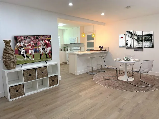 a view of a kitchen with furniture and wooden floor