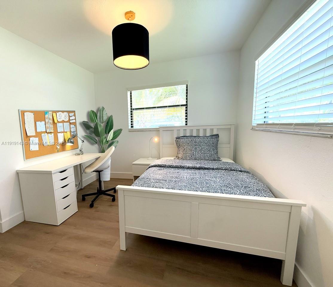 6250 Southwest 58th Place, Unit 1 South Miami, FL 33143 - Photo 11 of 13 a bedroom with a bed and a window