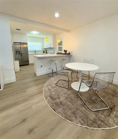 a kitchen with stainless steel appliances kitchen island granite countertop a sink and cabinets