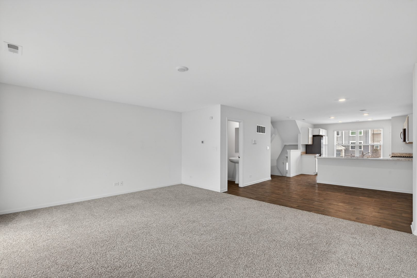 3831 Currant Lane Elgin, IL 60124 - Photo 11 of 25 a view of a big room with wooden floor and windows