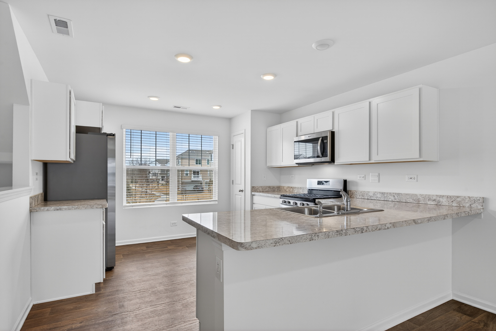 3831 Currant Lane Elgin, IL 60124 - Photo 7 of 25 a kitchen with stainless steel appliances granite countertop a sink stove and refrigerator