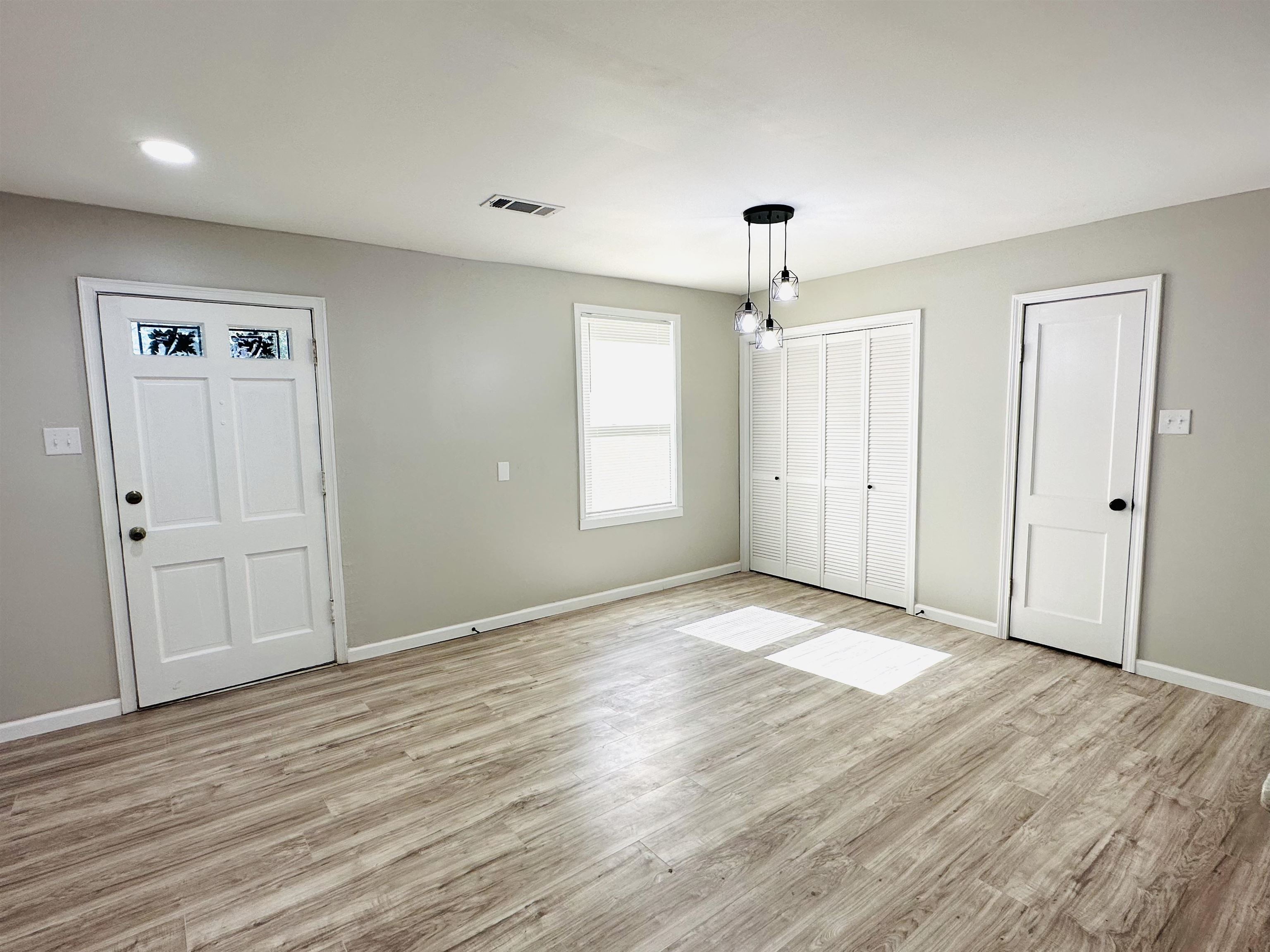 1340 Weiner Road Memphis, TN 38108 - Photo 2 of 27 a view of an empty room with window and wooden floor