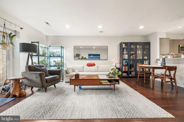 a bedroom with furniture and a wooden floor