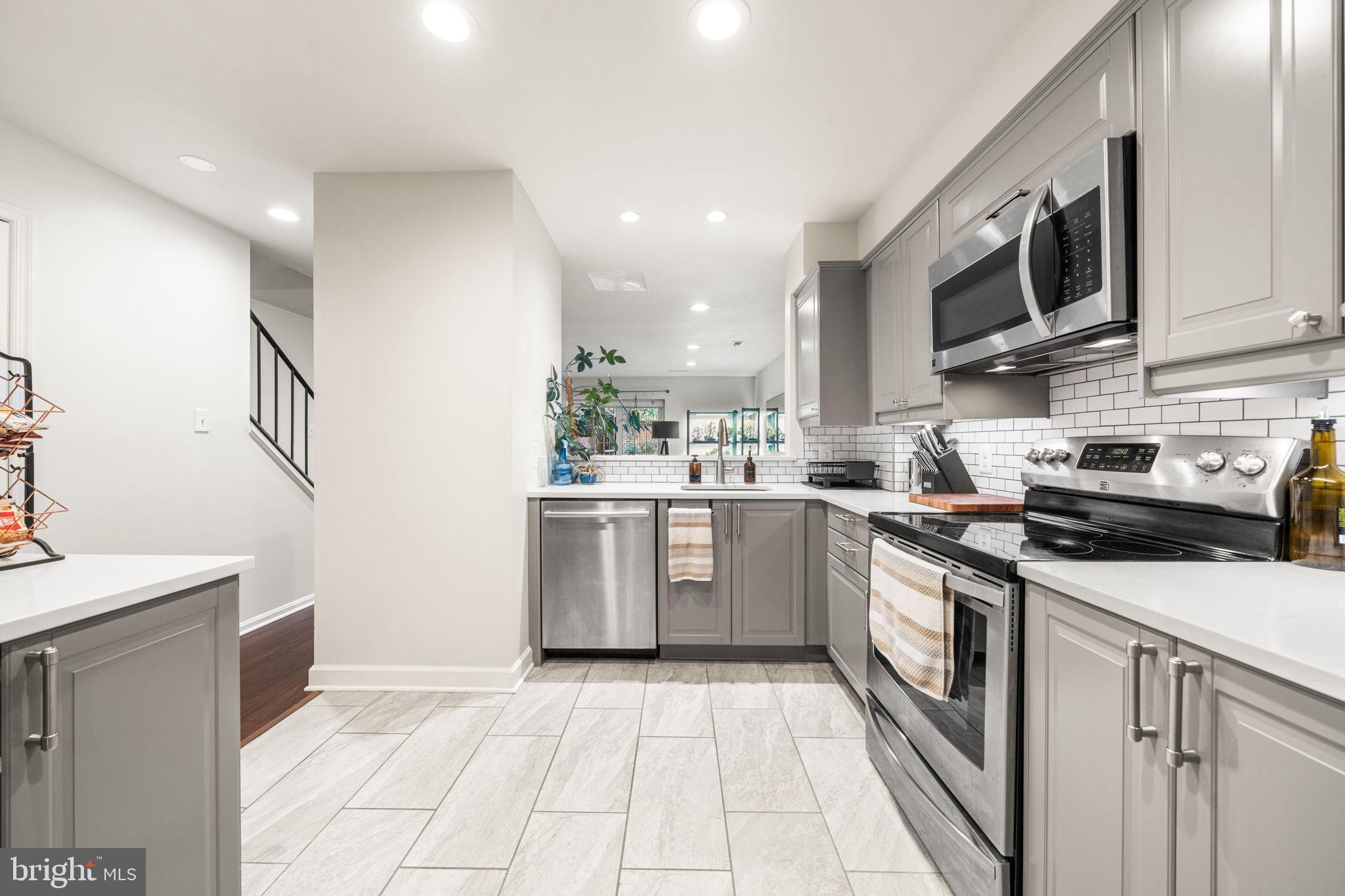 907 South Rolfe Street, Unit 1A Arlington, VA 22204 - Photo 15 of 36 a kitchen with stainless steel appliances granite countertop a sink and a stove