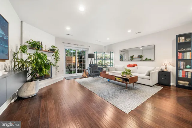 a bedroom with furniture and a wooden floor
