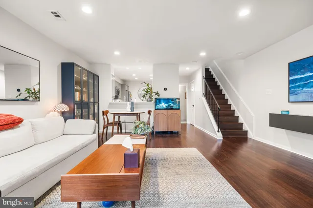a living room with furniture and wooden floor