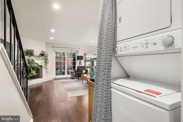 a view of washer and dryer with wooden floor