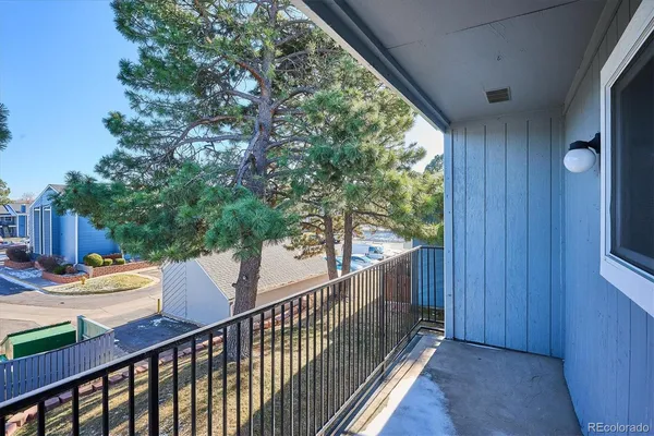 a view of balcony with wooden floor and fence