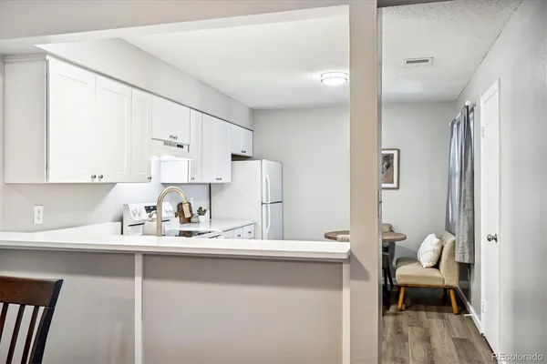 a kitchen with a sink cabinets and wooden floor