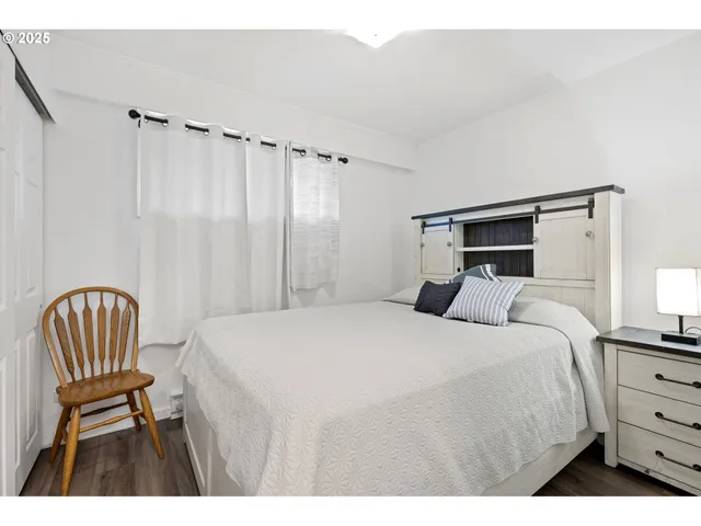 a bedroom with a bed and a chair