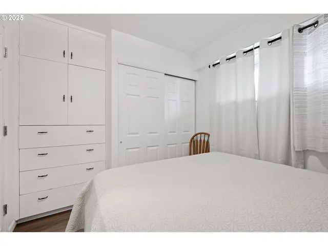 a bedroom with a bed and a dresser