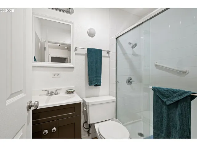 a bathroom with a sink a toilet a vanity and mirror