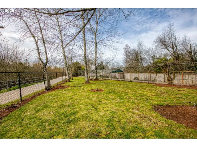 a view of yard with swimming pool and trees