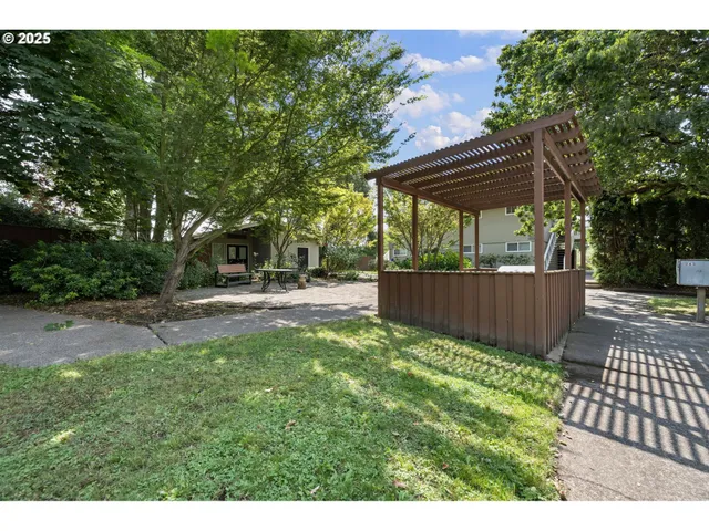 a view of a backyard with wooden fence