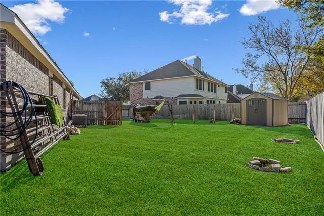 a view of a house with a backyard