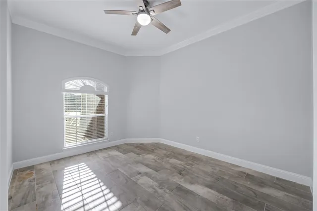a view of a livingroom with a ceiling fan and window