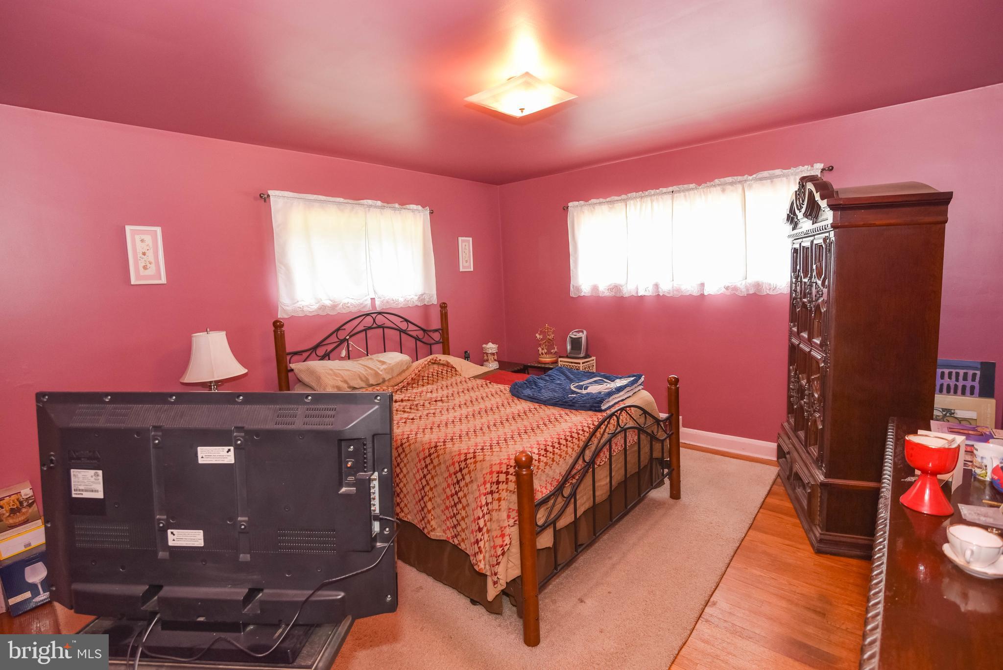 4428 Forge Road Perry Hall, MD 21128 - Photo 12 of 27 a bedroom with a bed and dresser with mirror