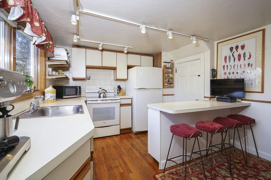 46 Reedsdale Road Milton, MA 02186 - Photo 8 of 18 a kitchen with stainless steel appliances a stove a sink dishwasher and a refrigerator with wooden floor