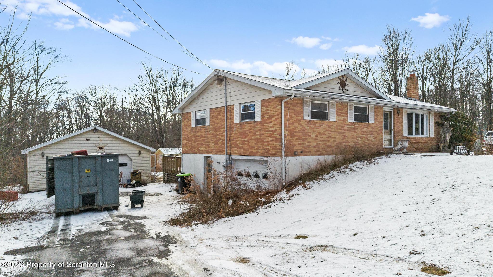 82 Jubilee Road Gouldsboro, PA 18424 - Photo 2 of 39 a front view of a house with a yard covered in snow