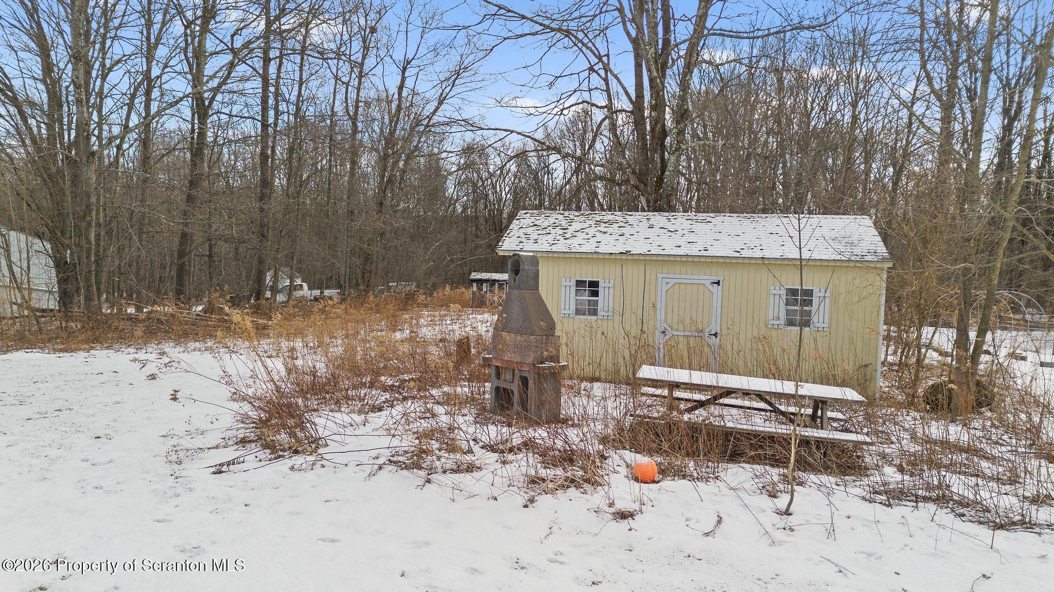 82 Jubilee Road Gouldsboro, PA 18424 - Photo 35 of 39 a backyard of a house with a large tree