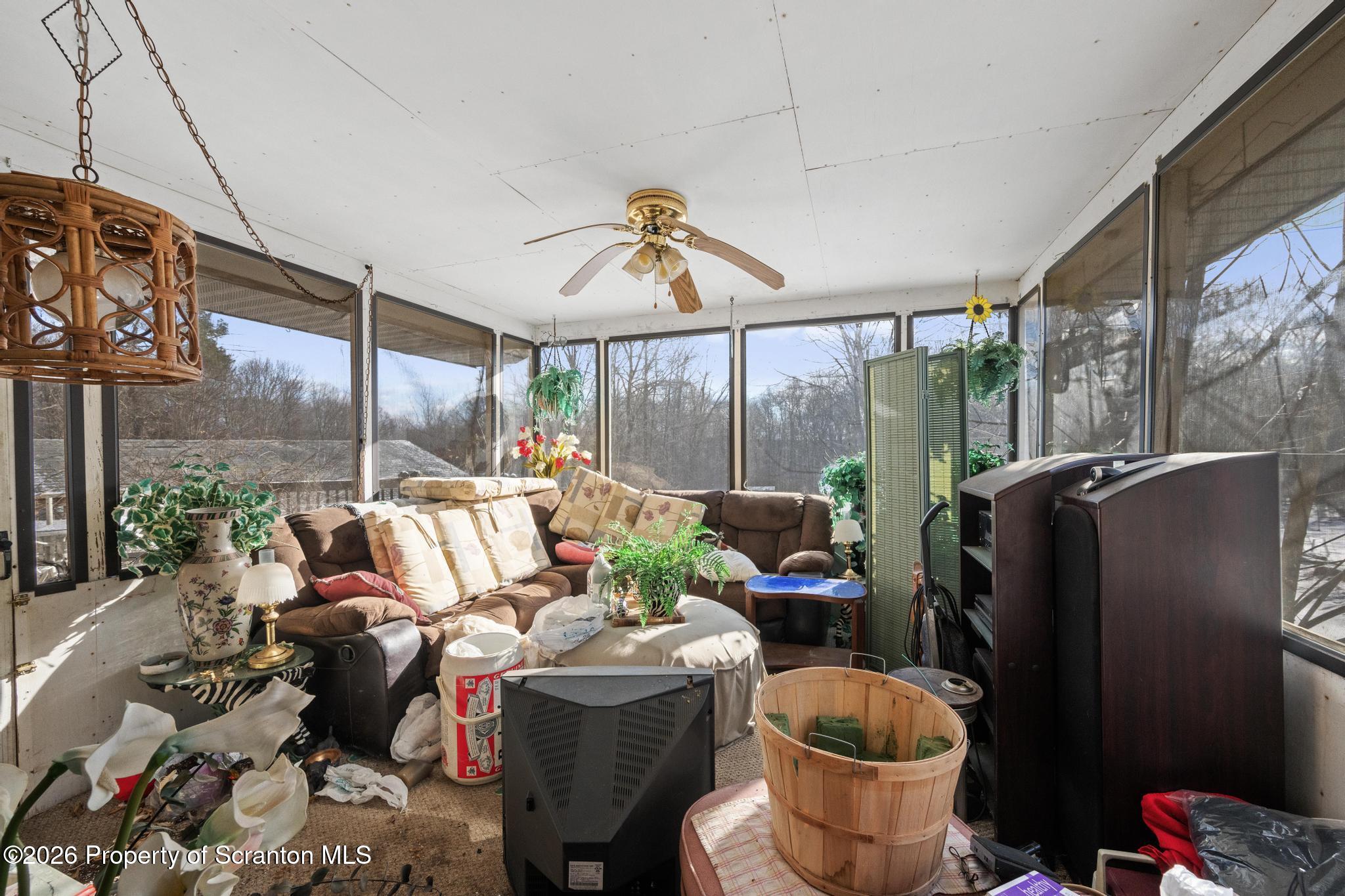 82 Jubilee Road Gouldsboro, PA 18424 - Photo 10 of 39 a living room with furniture and a floor to ceiling window