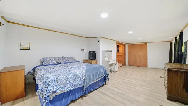 a bedroom with a bed and a television