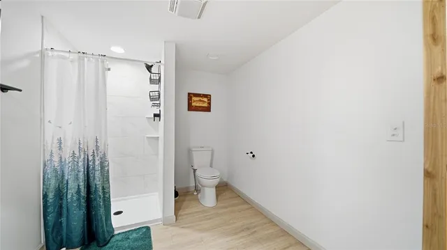 a bathroom with a shower and a toilet