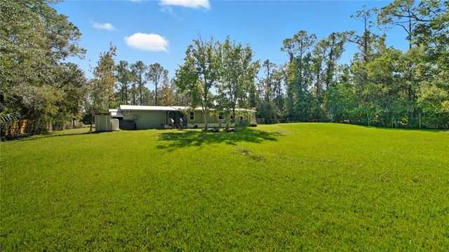 a view of a pool with a yard