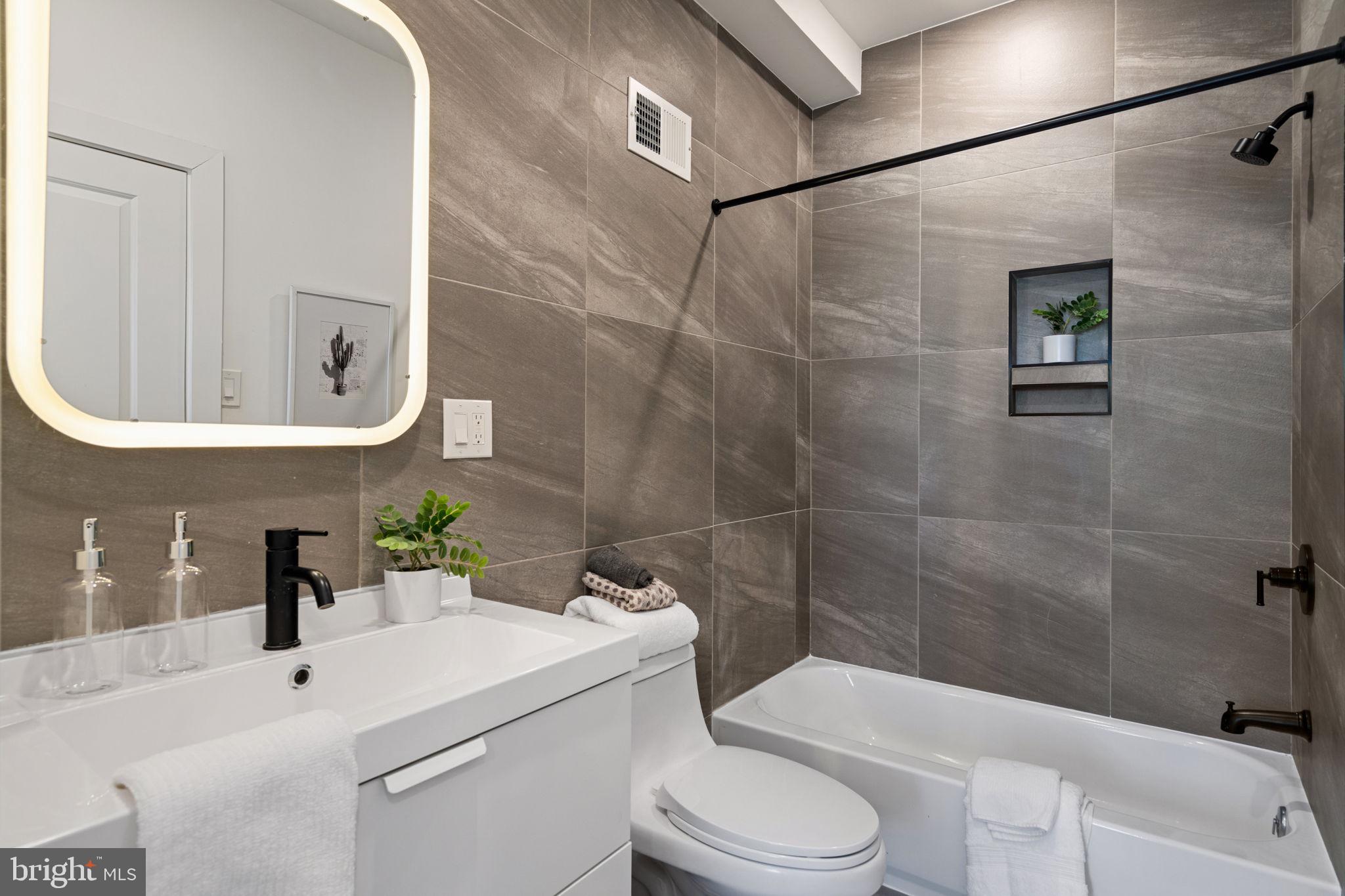 3973 Wyalusing Avenue Philadelphia, PA 19104 - Photo 14 of 39 a bathroom with a sink a toilet and shower