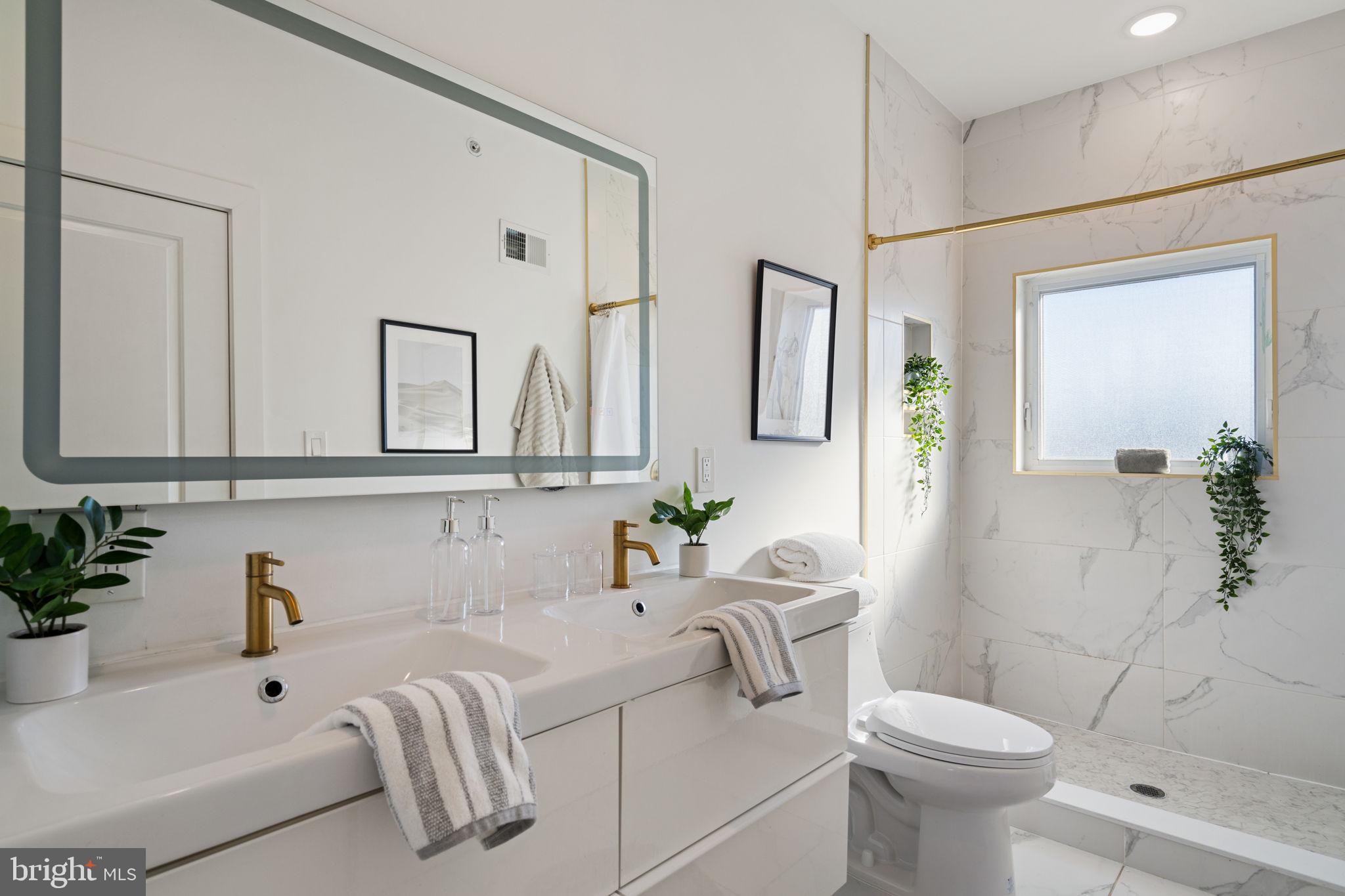 3973 Wyalusing Avenue Philadelphia, PA 19104 - Photo 25 of 39 a bathroom with a sink a toilet and mirror