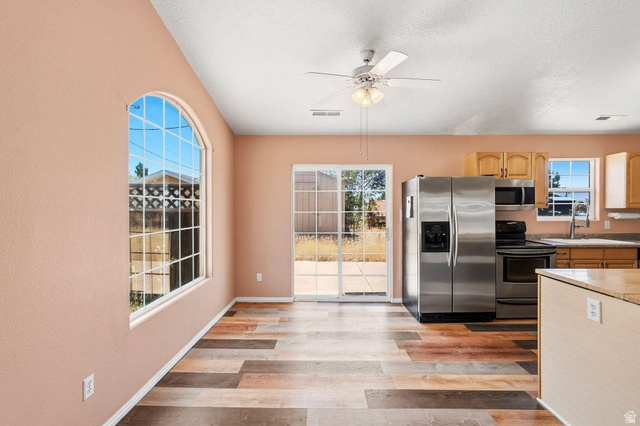 132 Rex Layne Drive Central, UT 84722 - Photo 5 of 39 Spacious kitchen and dining area featuring wood-finish flooring and a ceiling fan