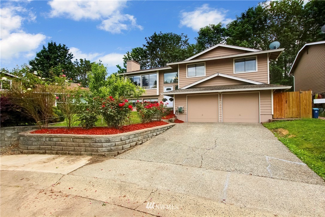 a front view of a house with a garden