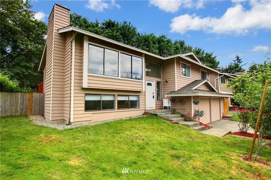 21928 8th Place West Bothell, WA 98021 - Photo 2 of 31 a front view of a house with a yard table and chairs