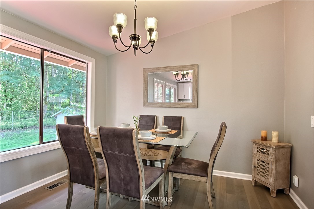 21928 8th Place West Bothell, WA 98021 - Photo 11 of 31 a view of a dining room with furniture window and wooden floor