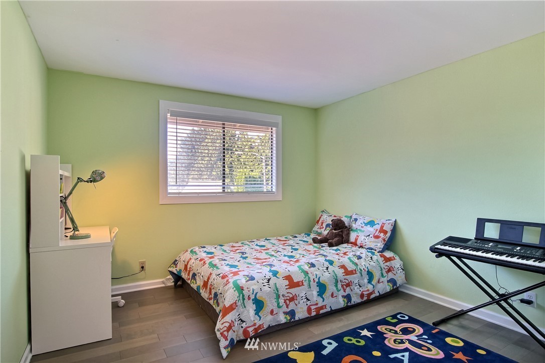21928 8th Place West Bothell, WA 98021 - Photo 18 of 31 a bedroom with a bed and wooden floor