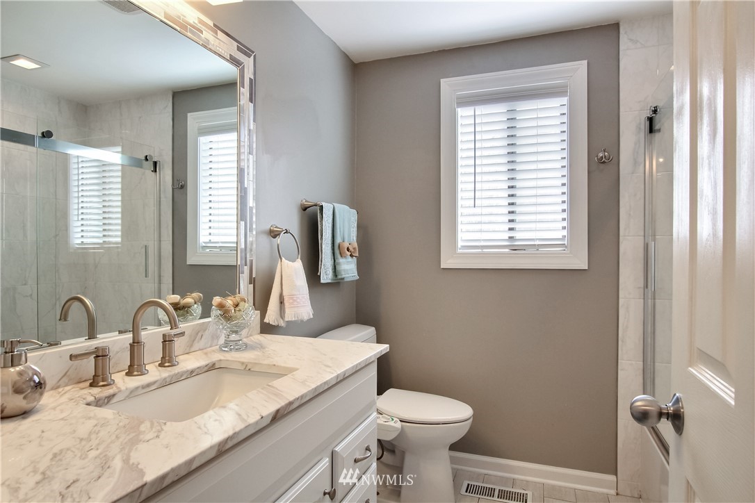 21928 8th Place West Bothell, WA 98021 - Photo 20 of 31 a bathroom with a granite countertop sink toilet and mirror