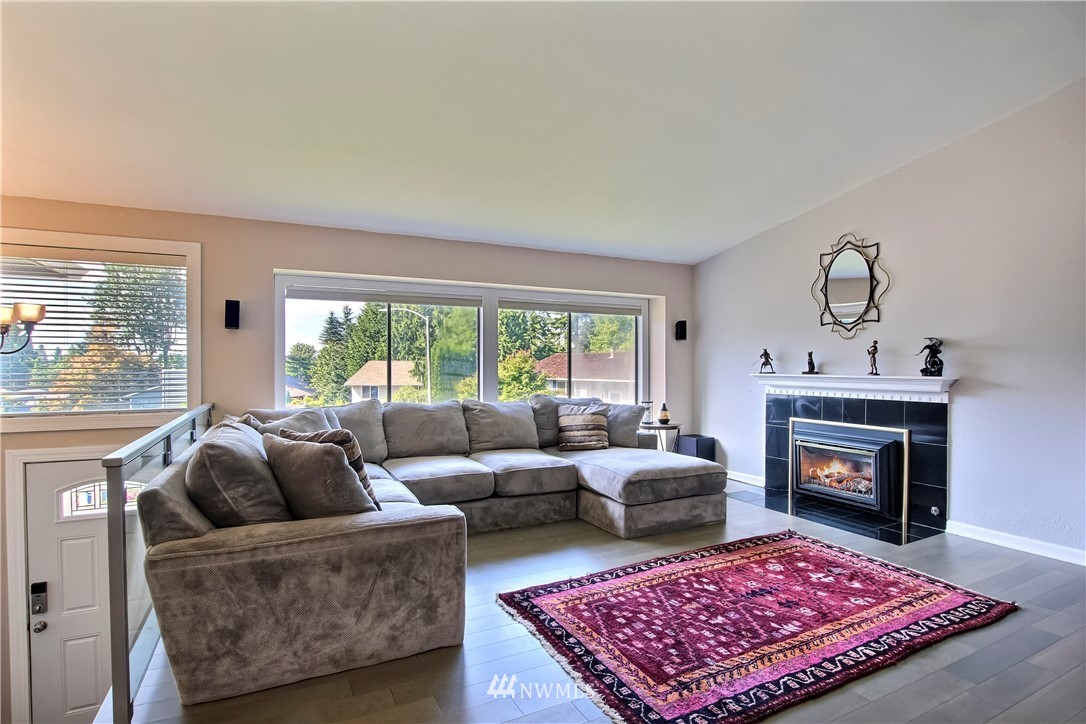 21928 8th Place West Bothell, WA 98021 - Photo 3 of 31 a living room with furniture a rug a fireplace and a large window