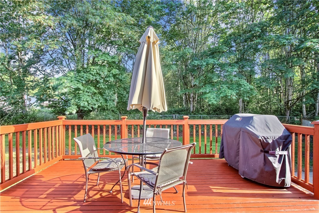 21928 8th Place West Bothell, WA 98021 - Photo 26 of 31 a view of a deck with a table and chairs with wooden floor and fence