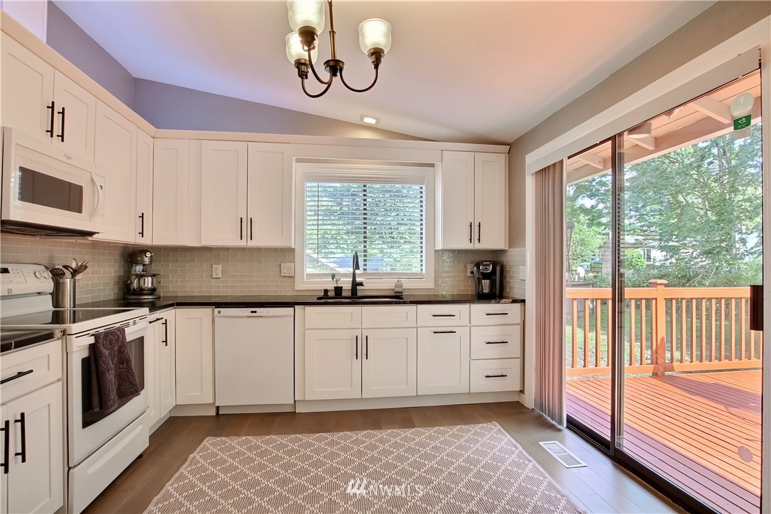 21928 8th Place West Bothell, WA 98021 - Photo 7 of 31 a kitchen with stainless steel appliances granite countertop a stove a sink and a microwave