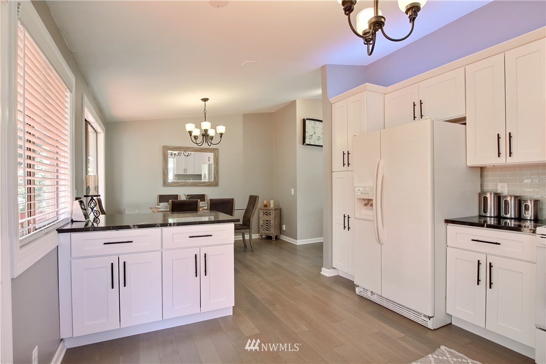 21928 8th Place West Bothell, WA 98021 - Photo 9 of 31 a kitchen with white cabinets and sink