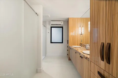 a bathroom with a double vanity sink and mirror