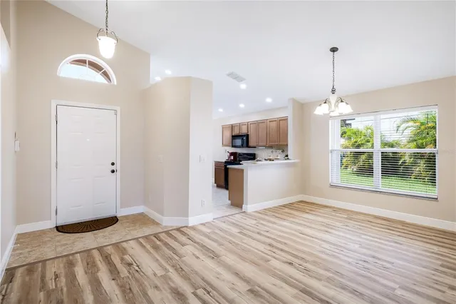 a view of a kitchen with wooden floor windows and a ceiling fan