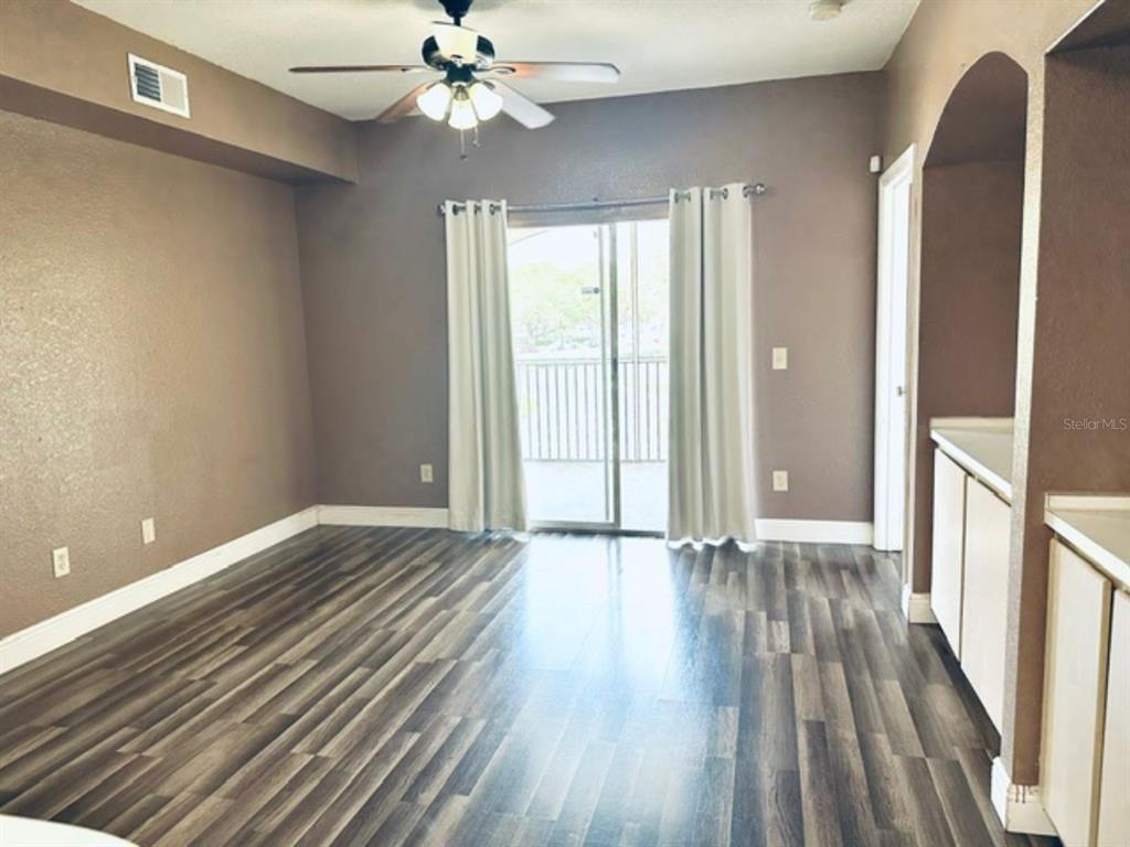 822 Camargo Way, Unit 204 Altamonte Springs, FL 32714 - Photo 13 of 32 a view of an empty room with wooden floor and a window