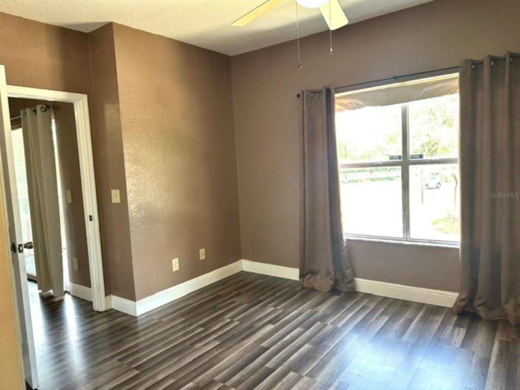 822 Camargo Way, Unit 204 Altamonte Springs, FL 32714 - Photo 14 of 32 an empty room with wooden floor and windows
