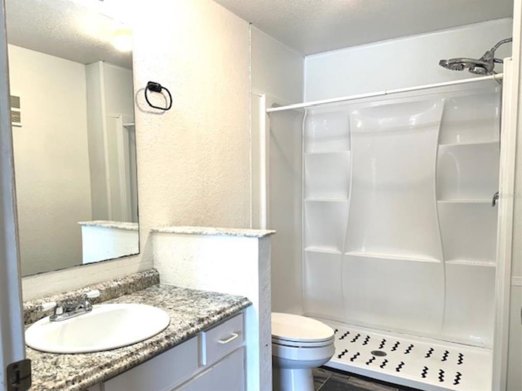 822 Camargo Way, Unit 204 Altamonte Springs, FL 32714 - Photo 17 of 32 a bathroom with a sink a toilet and a mirror
